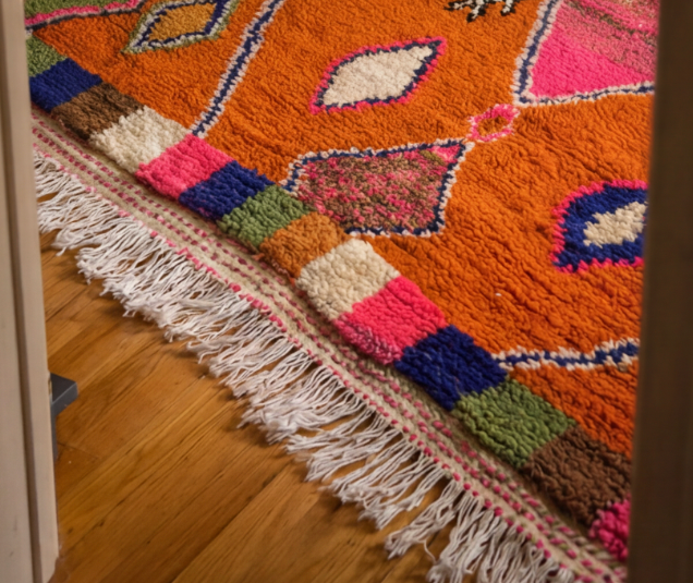 Noura orange rug in colourful artist studio - bold Moroccan hand-knotted wool rug